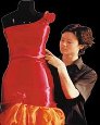 person fitting a dress on a form