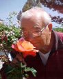 man smelling flower