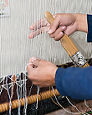 hands using loom